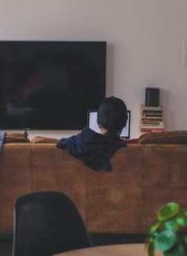 photo du salon de un appartement avec un canape une television et une femme